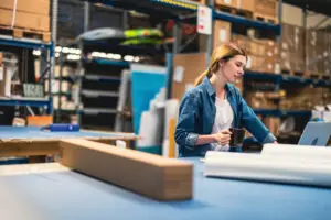 Woman in warehouse evaluating delivery options